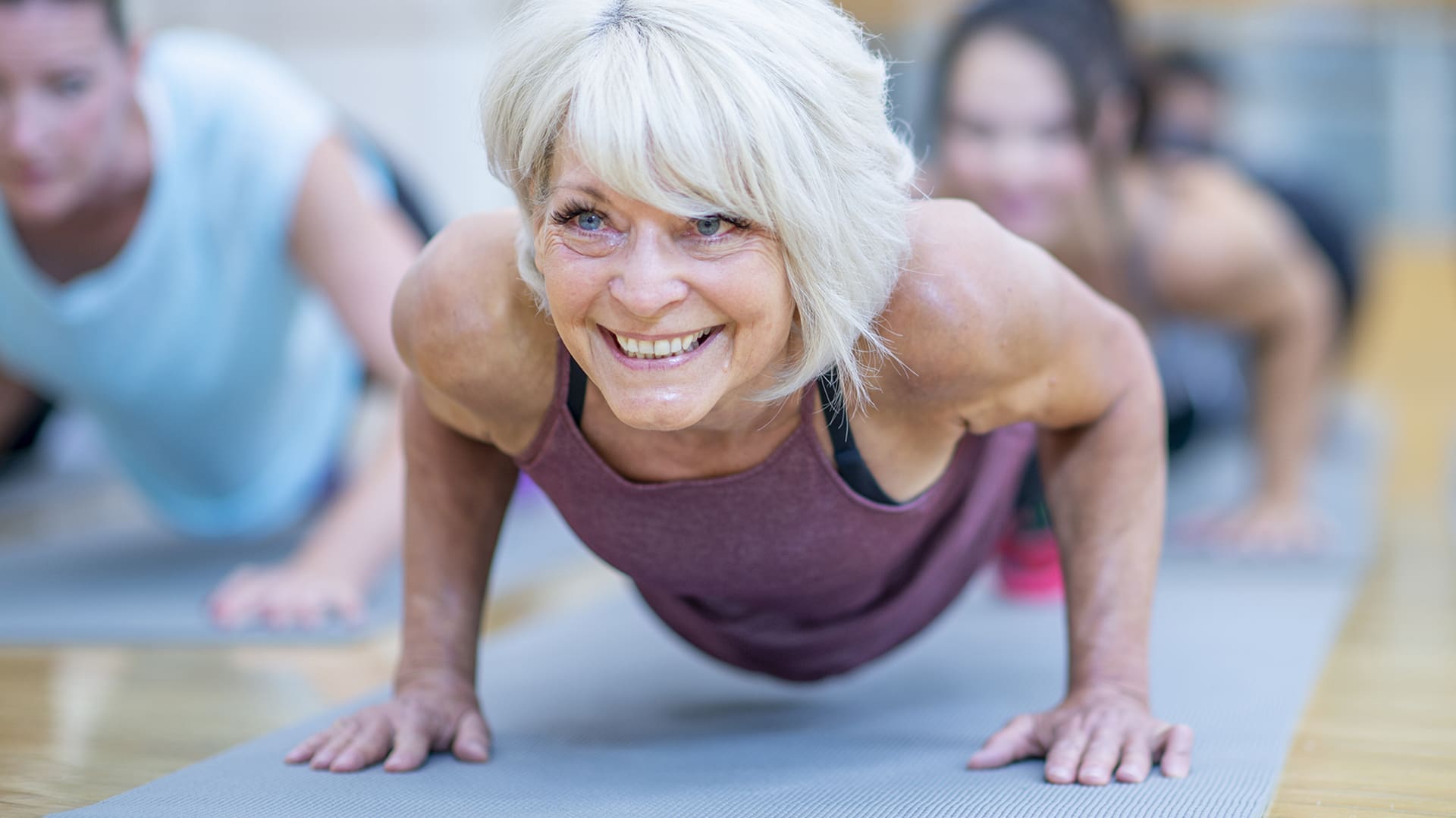 Senior woman does a push up.