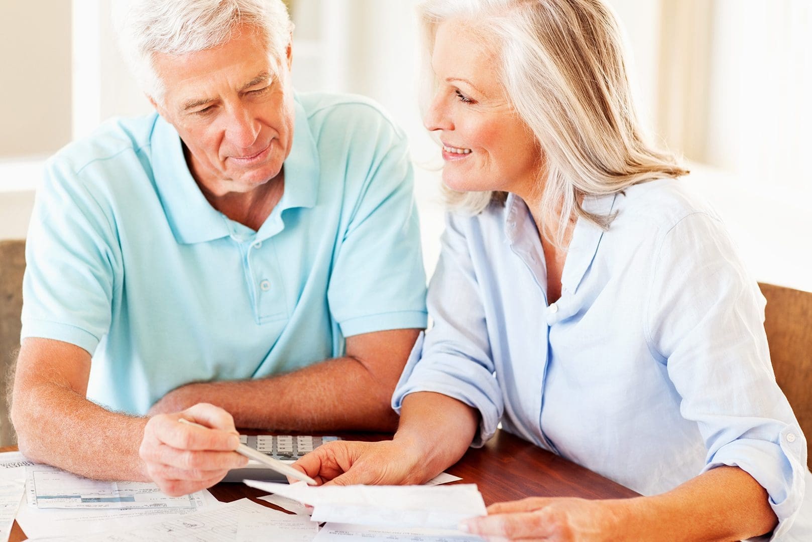 senior couple reviewing their finances at the table