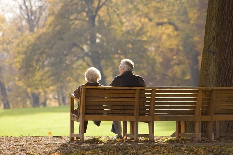 Elderly couple on park bench